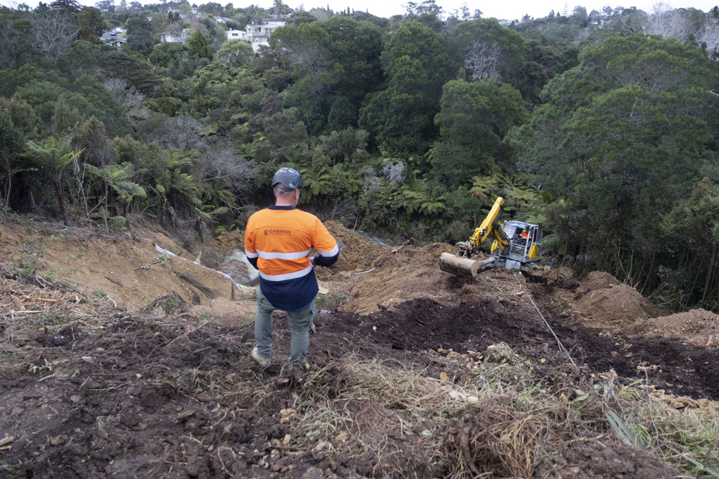 A man looking over a dig site
