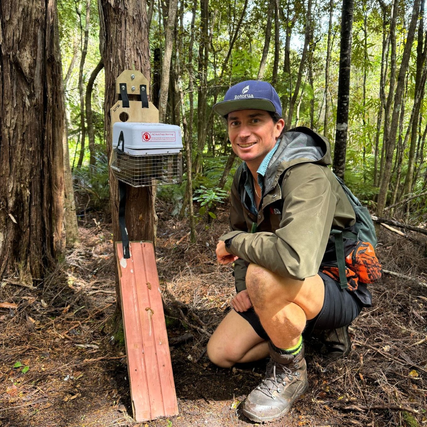 A community volunteer laying baits in the forest. 