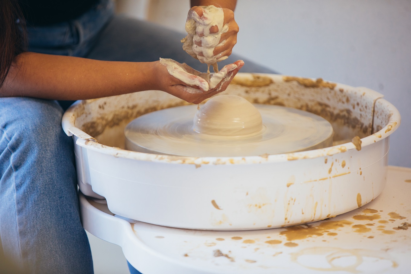 Participant using one of the pottery wheels at Studio One Toi Tū