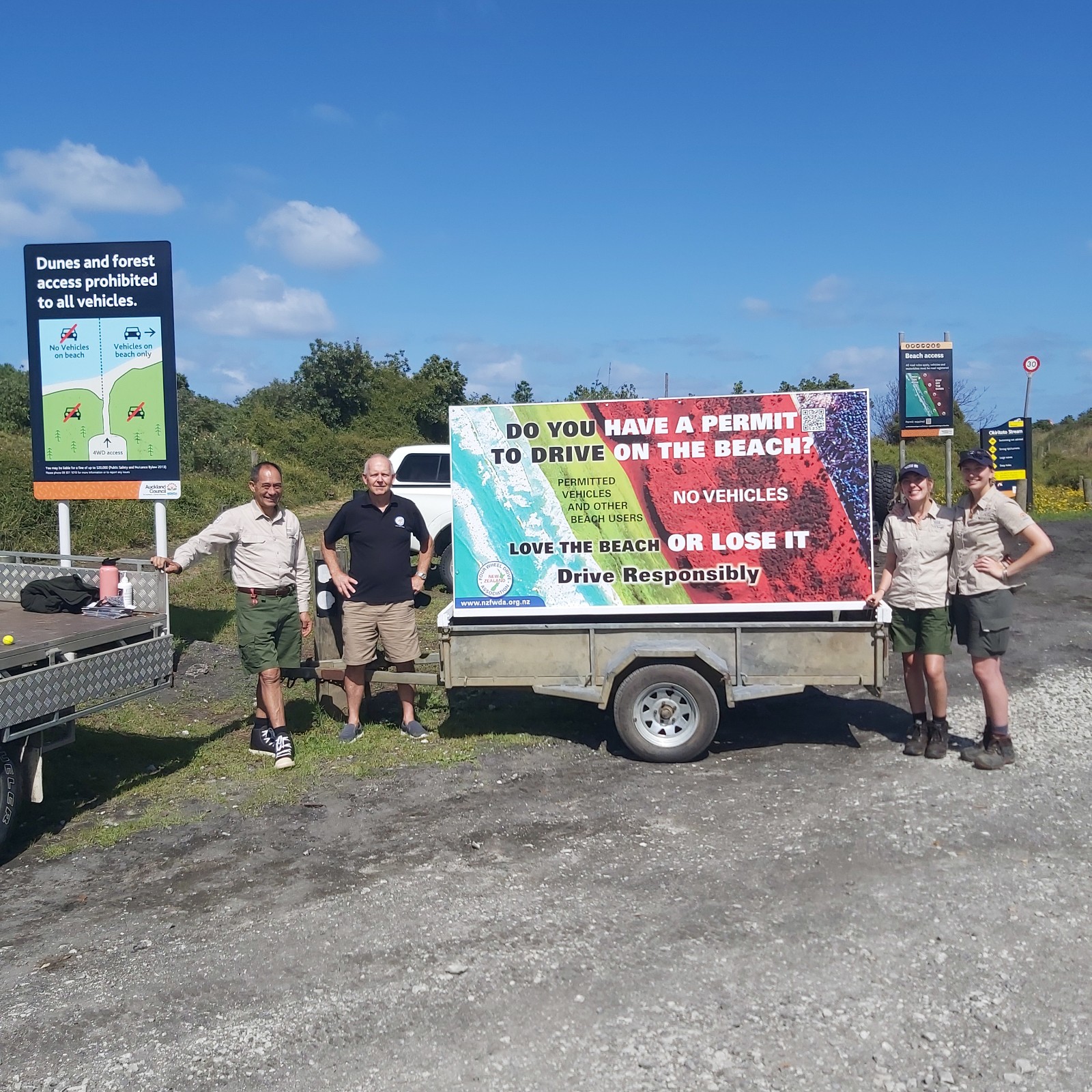 NZ 4WD Association's roving billboard to help educate drivers. L to R: Auckland Council Ranger Joe Rangihuna, NZ4WD Association's Peter Vahry, Auckland Council Summer Ranger Tara McGuire and Auckland Council Summer Ranger Sydney Verrenkamp.