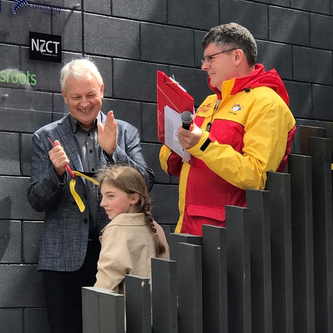 The ceremonial cutting of the ribbon was jointly carried out by Mayor Phil Goff and the granddaughter of the club patron Sir Bob Harvey. Credit Karekare Surf Lifesaving Club