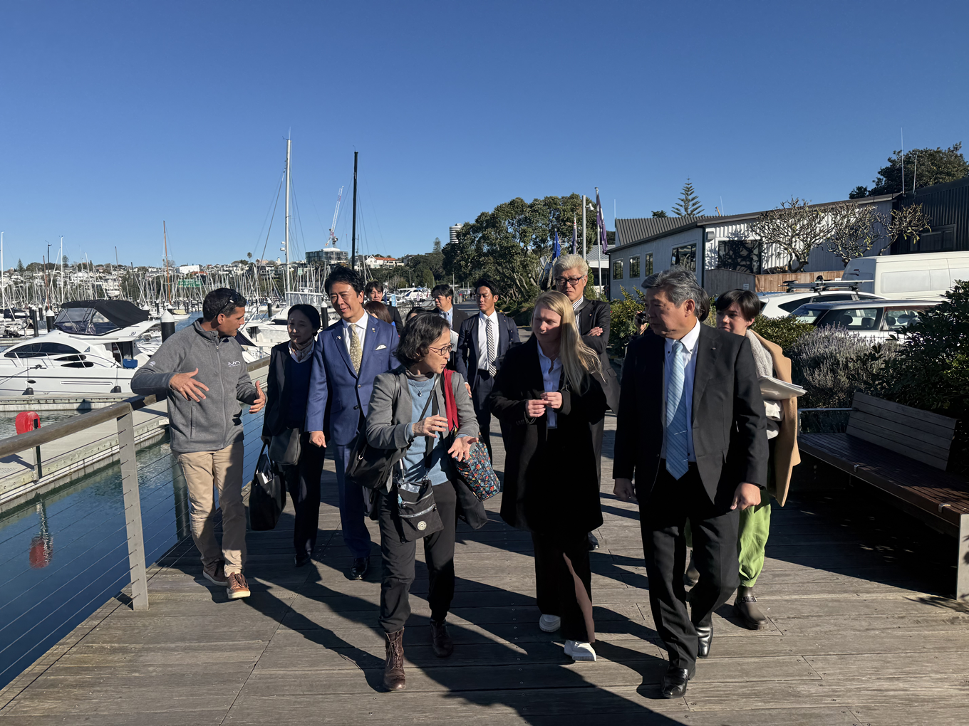 A group of delegates walking along the waterside boardwalk. 