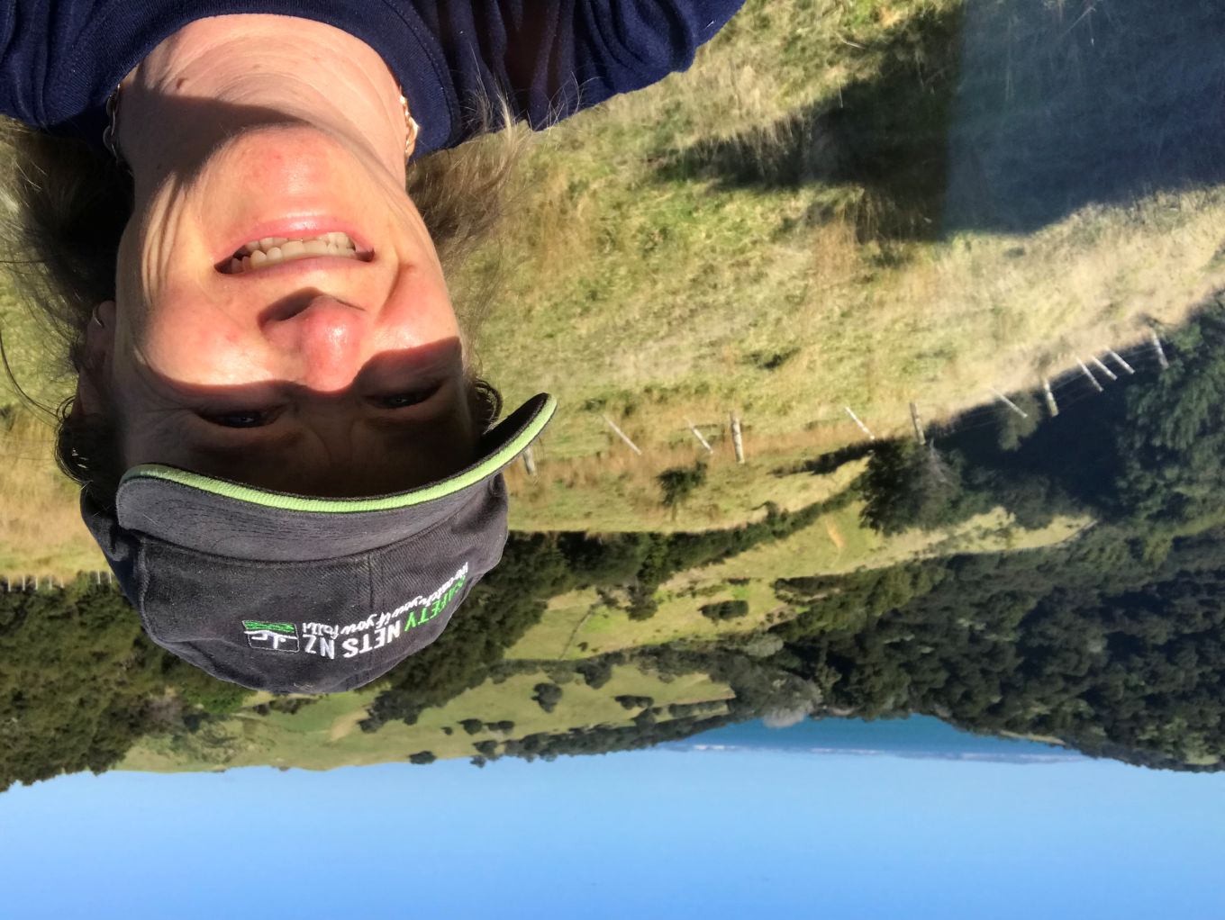 A woman taking a selfie in a field. 