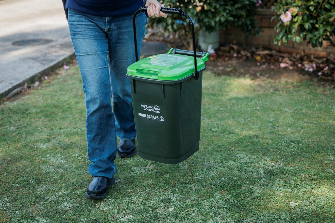 A person taking their food scraps out. 