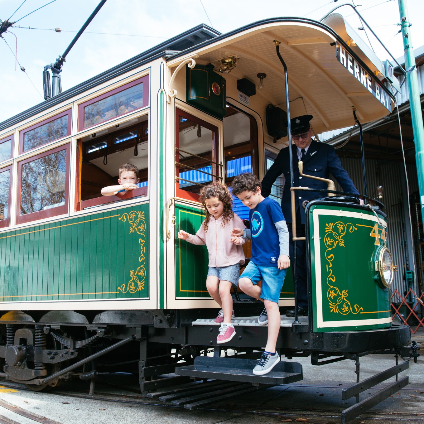 Children stepping off the tram at MOTAT. 