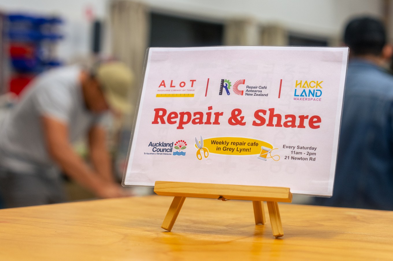 A sign saying repair and share. 