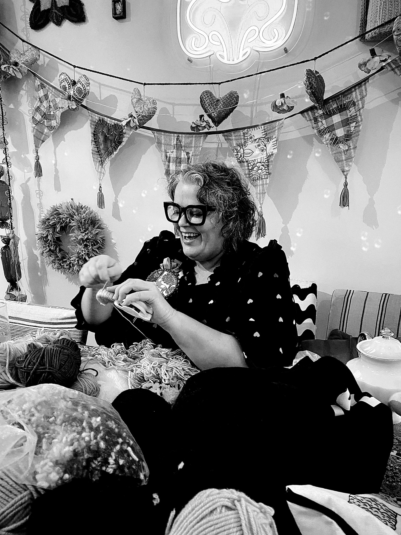 A lady using wool to knit. 