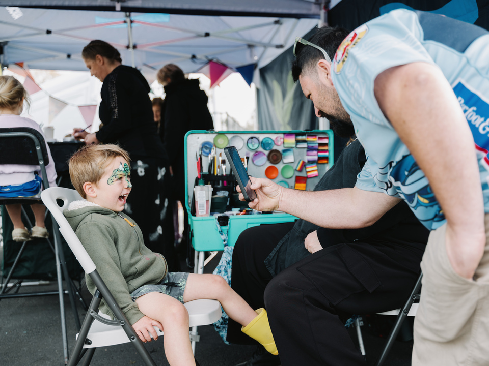 A child getting his face painted. 