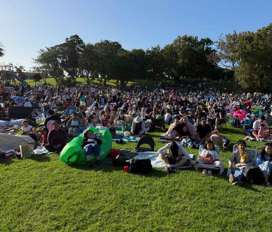 A local community at a movies in parks event. 