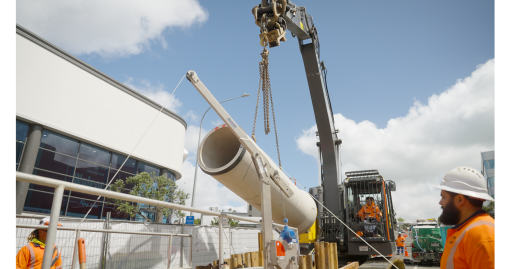 Digger Lifting Low Carbon Pipe Into Drain (1)