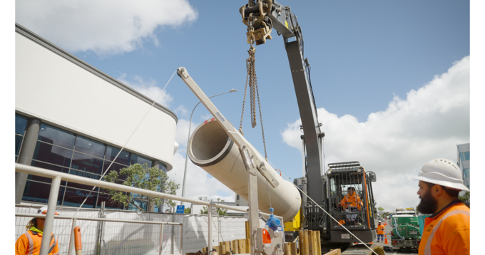 Digger Lifting Low Carbon Pipe Into Drain (1)