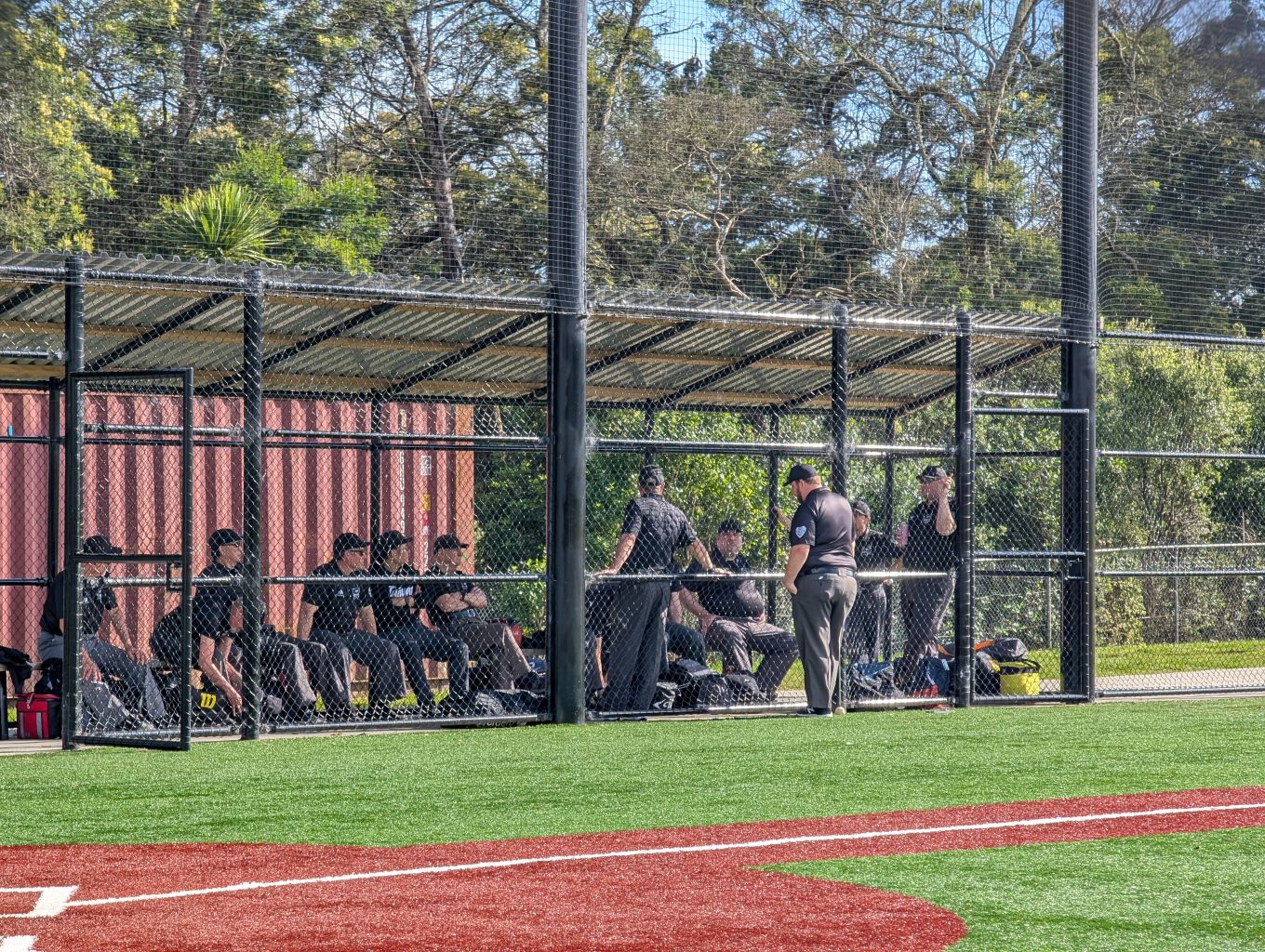 A softball team in the bench warming section. 