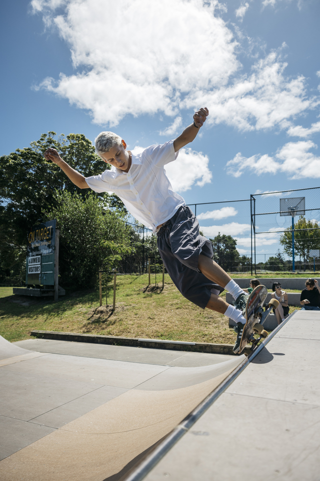 A young man skateboarding on a ramp.