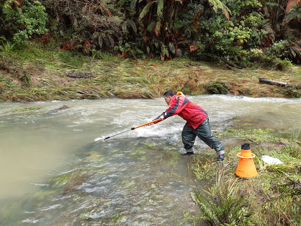A Man Cleaning A Stream