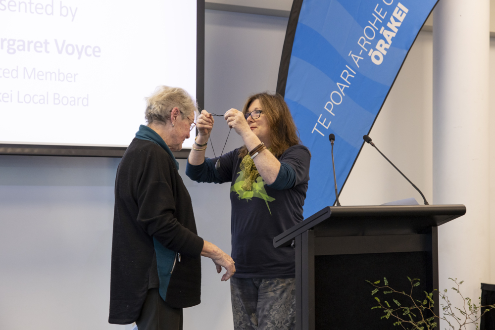 Pat Northey (left) being presented with a pounamu by Margaret Voyce.
