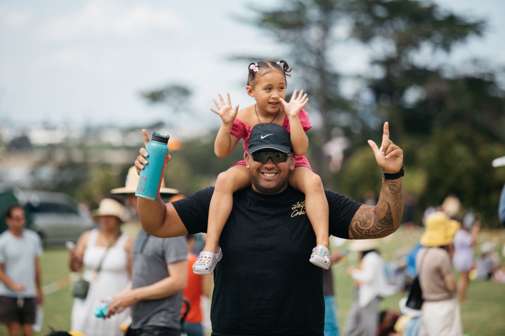 A Man With A Girl On His Shoulders