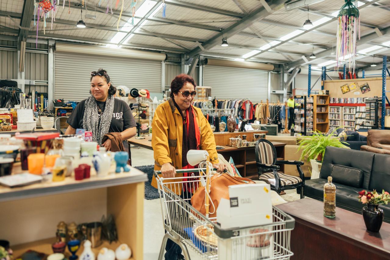 A women pushing a trolley at a local community recycling centre. 