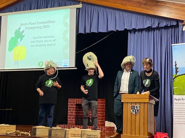 Pest Free Howick Moth plant competition coordinators Nigel Zhang on the left, Ethan McCormick middle  and Howick Local Board Chair, Damian Light getting into the ‘feeler’ of things.