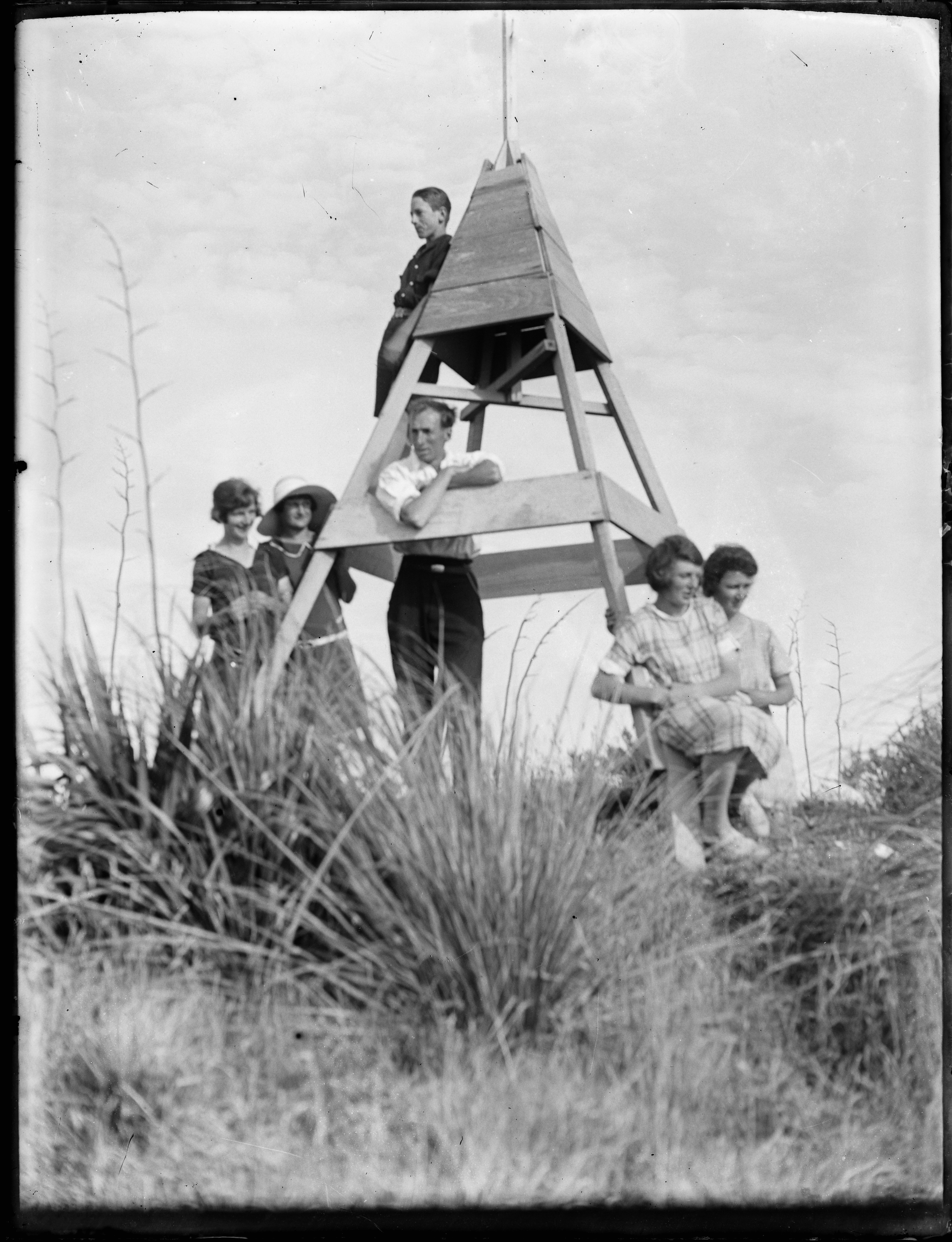 Auckland Libraries Heritage Collection 743-9343. Photographer Albert Hague Jones. Group at Whatipu trig including Anne Jones (nee Cooper), Gladys Cooper, Burt Jones and Clifford Jones. 1920s.
