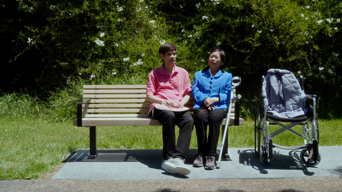 Two people on a park bench