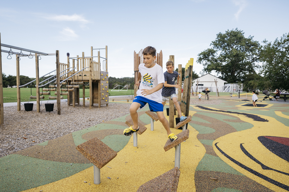 Two young boys playing on a local playground. 