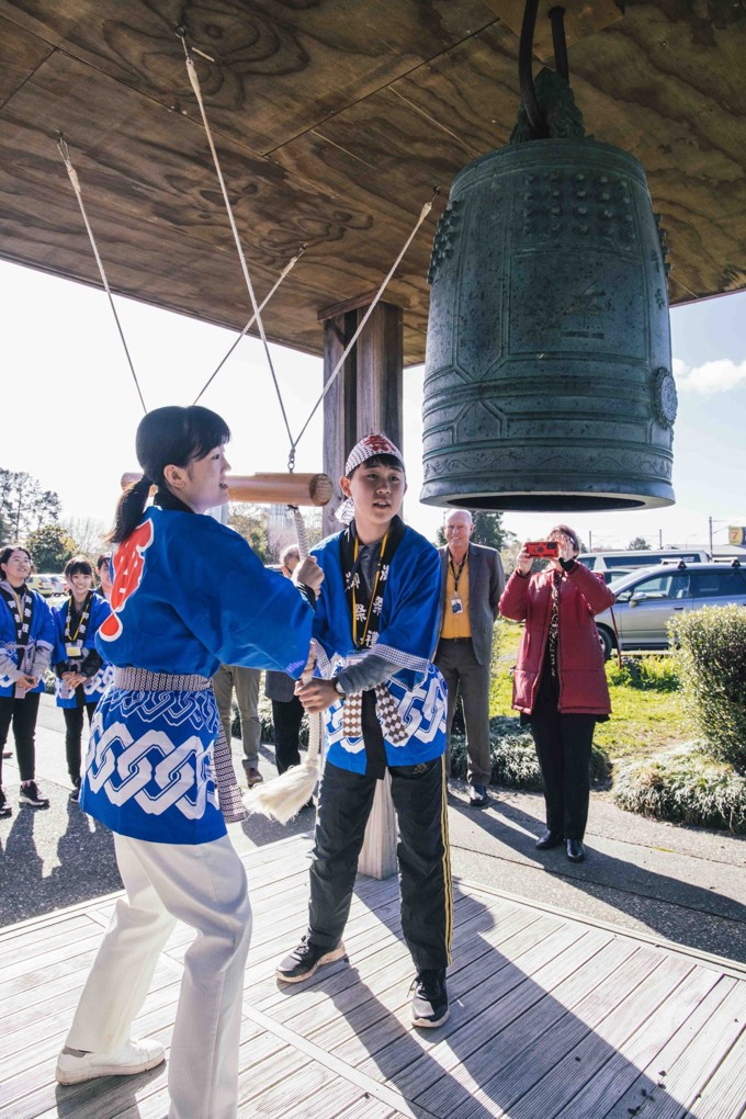 Students ringing Peace Bell