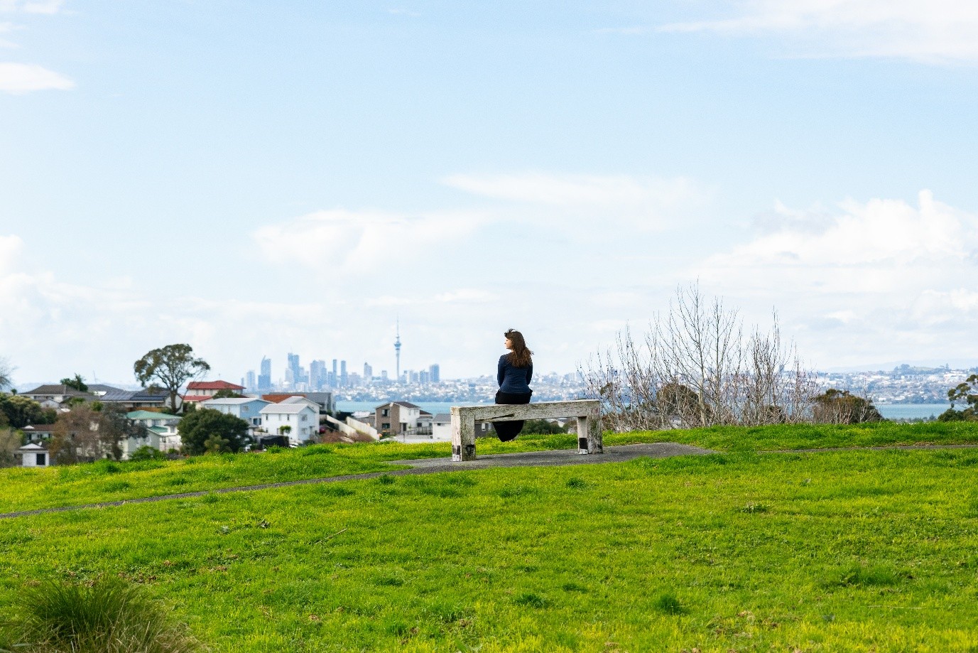 A woman looking out on the city. 