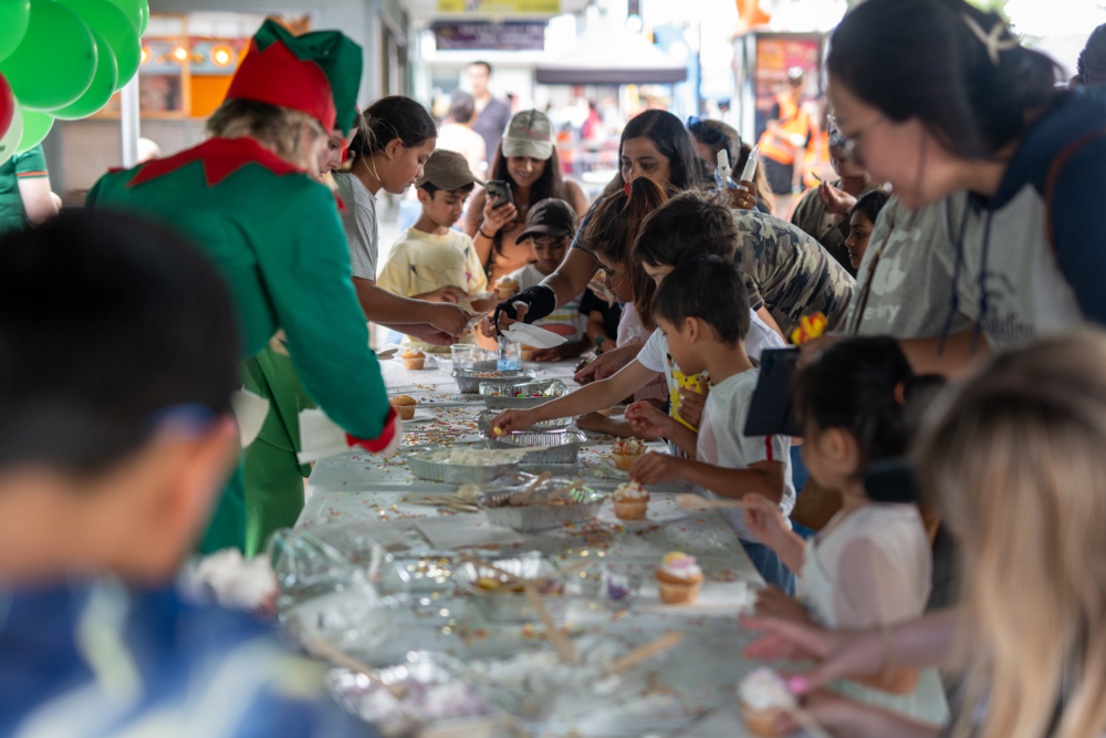 Performers helping kids make cupcakes.