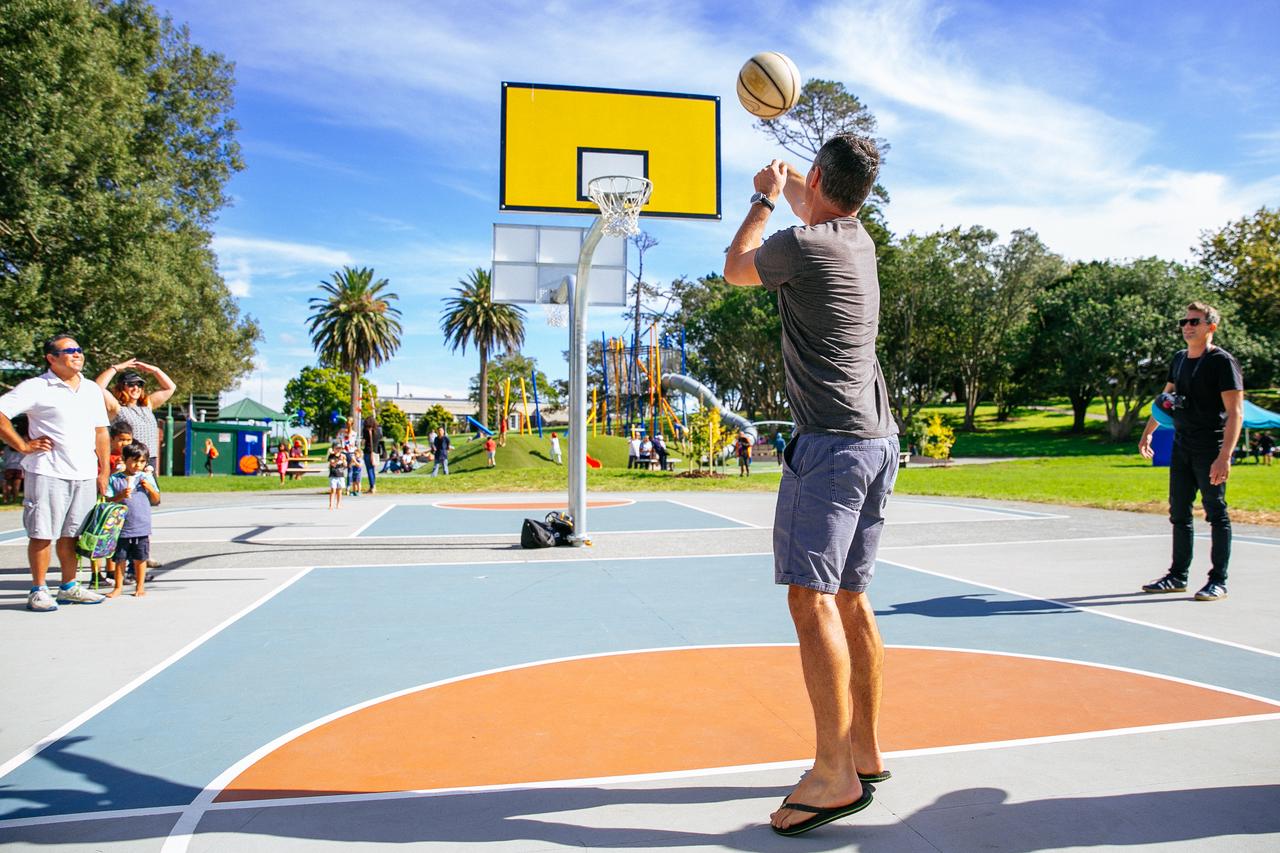 A person playing basketball on a basketball court. 
