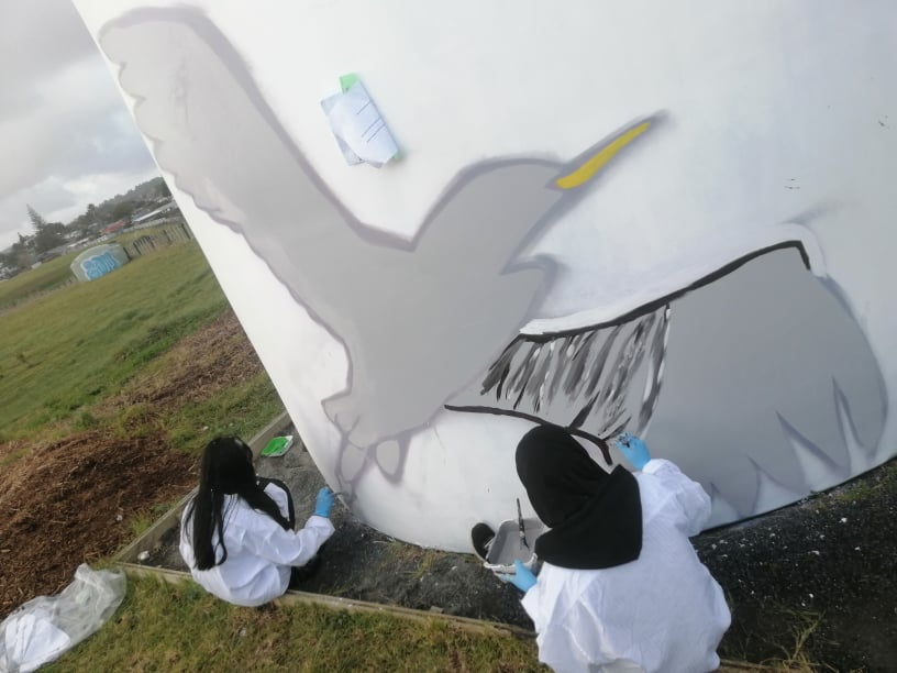 Students get to work on turning the tagged water tanks into urban art murals.