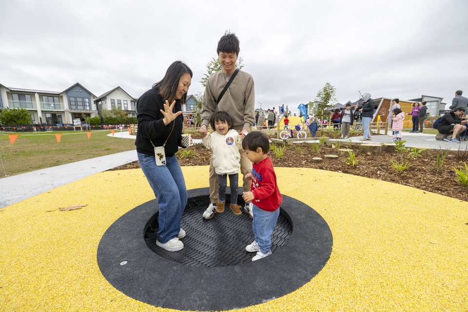 A family bouncing on a trampoline. 