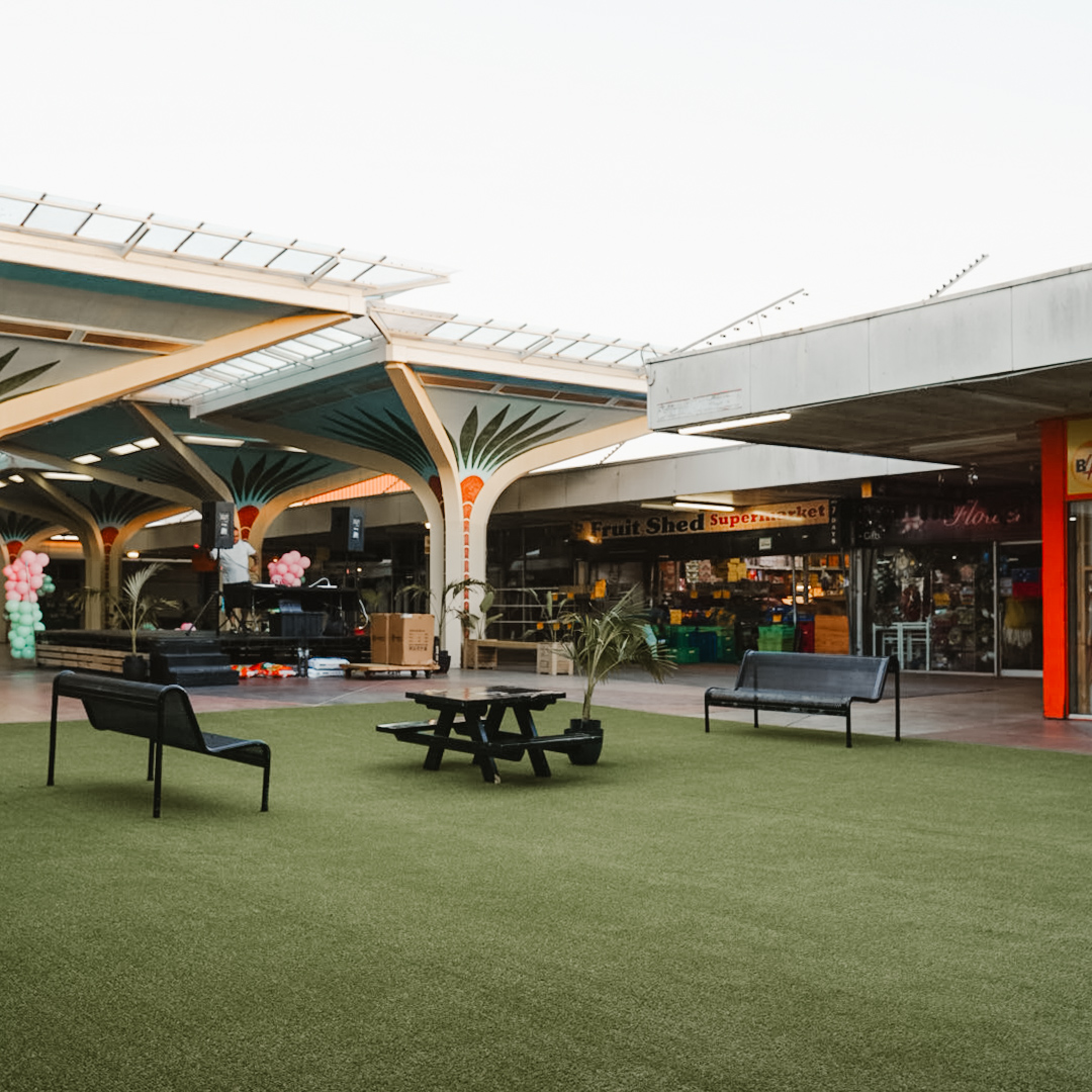 Turf, bench and picnic chairs inside the town centre.