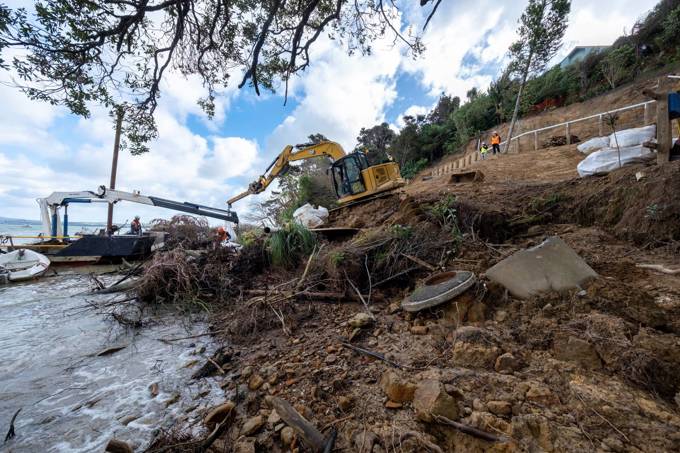 A Digger Clears Up Slips At Charcoal Bay Beach In Beach Haven