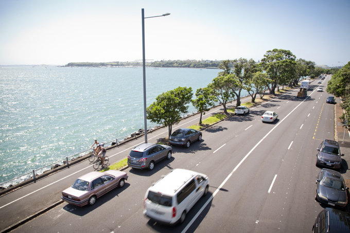 Road running alongside the sea with traffic flowing