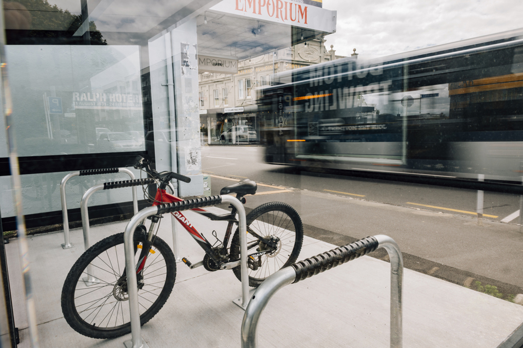 A bike parked on a busy road