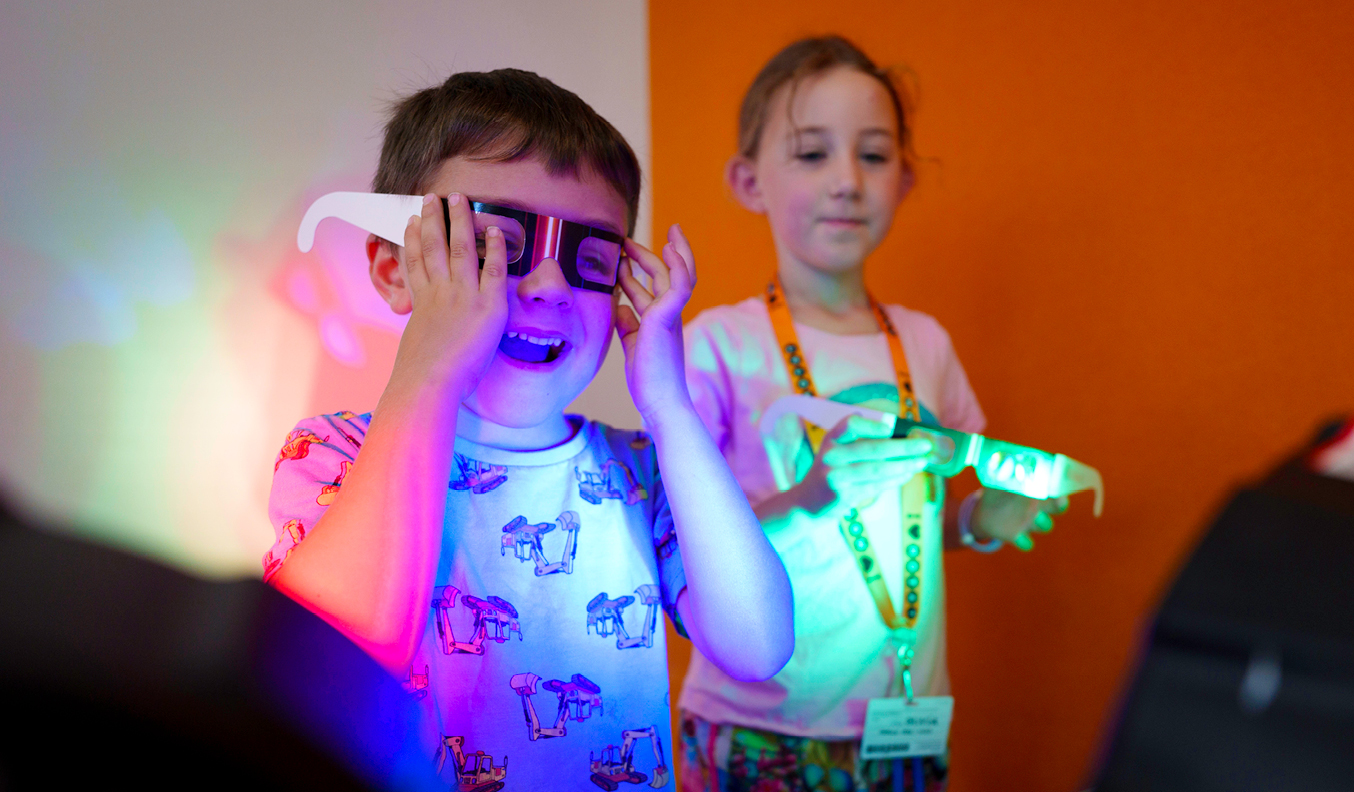 Children playing with neon lit glasses. 