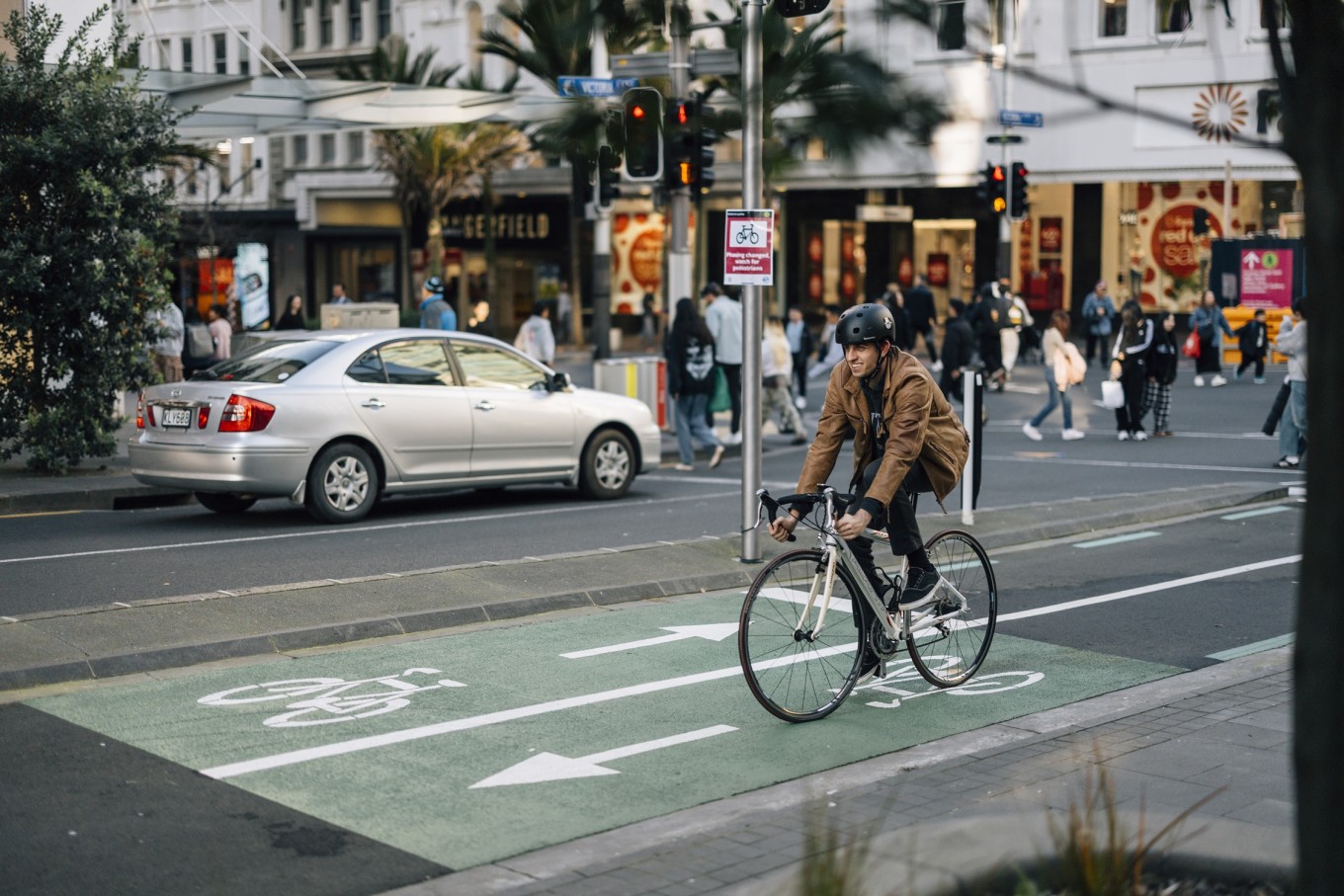 Another cyclist riding along the main path on Queen St. 