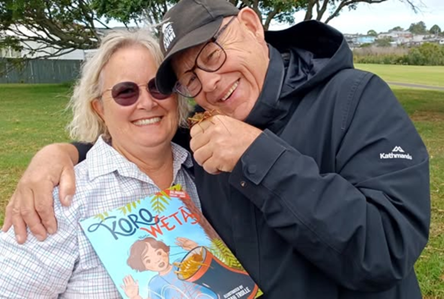A old couple holding a picture book. 