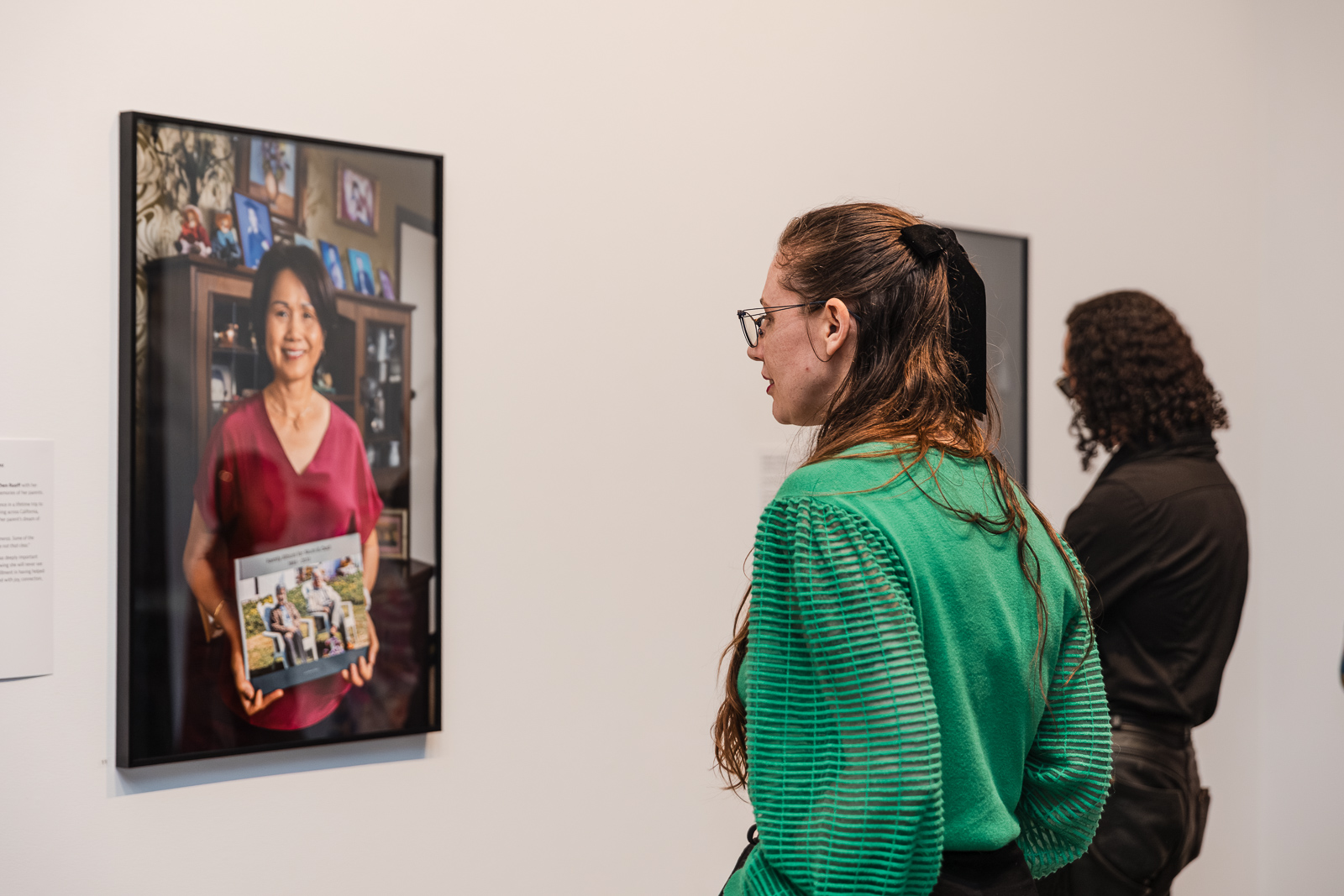 A woman looking at a painting. 