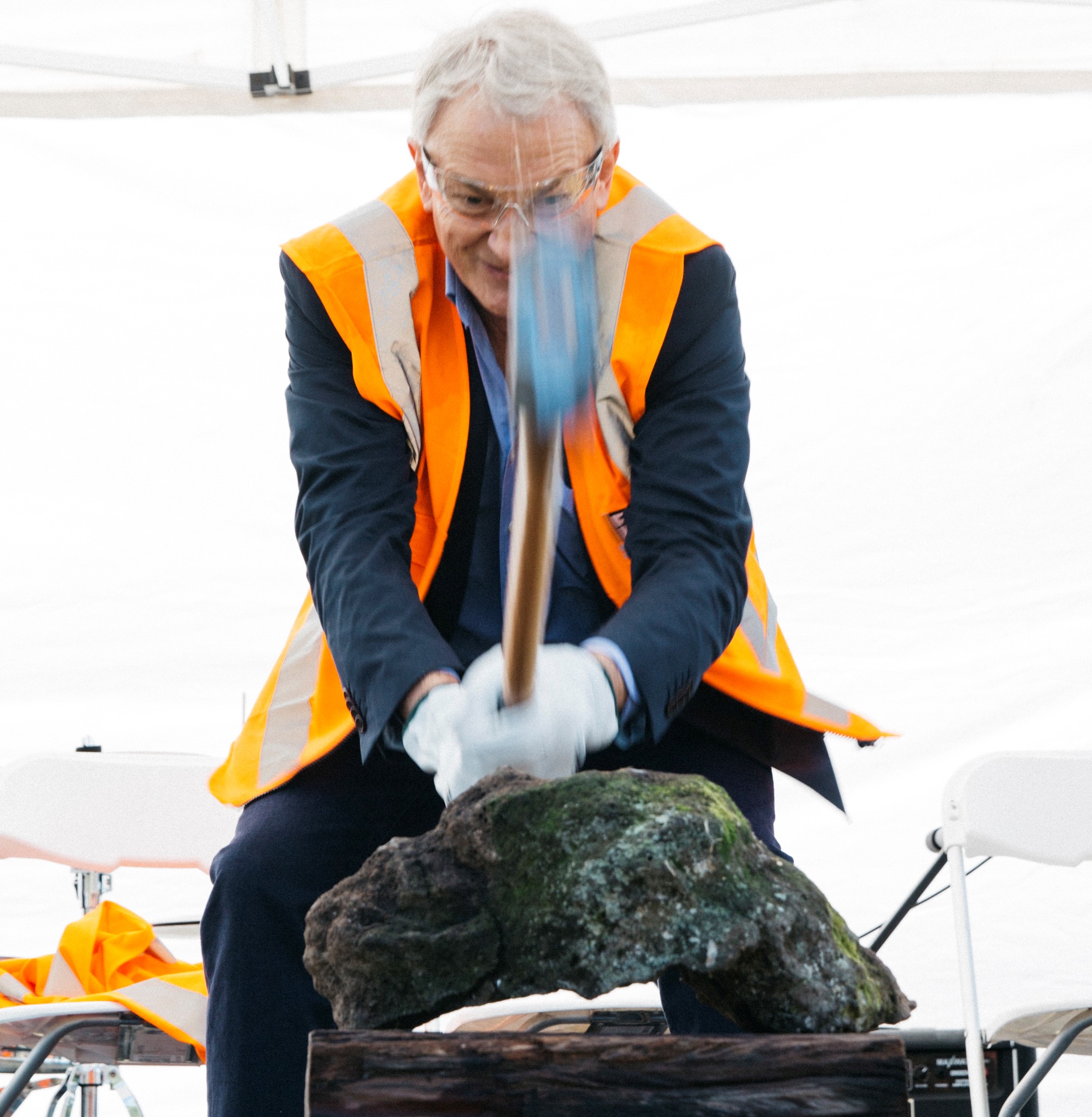 Mayor Phil Goff breaking basalt for the Te Auaunga Oakley Creek project in 2016