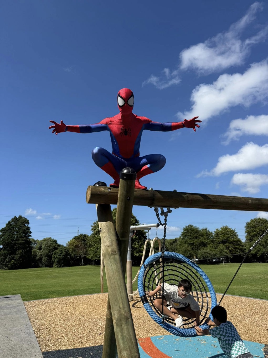 Spider man hanging out at a local playground