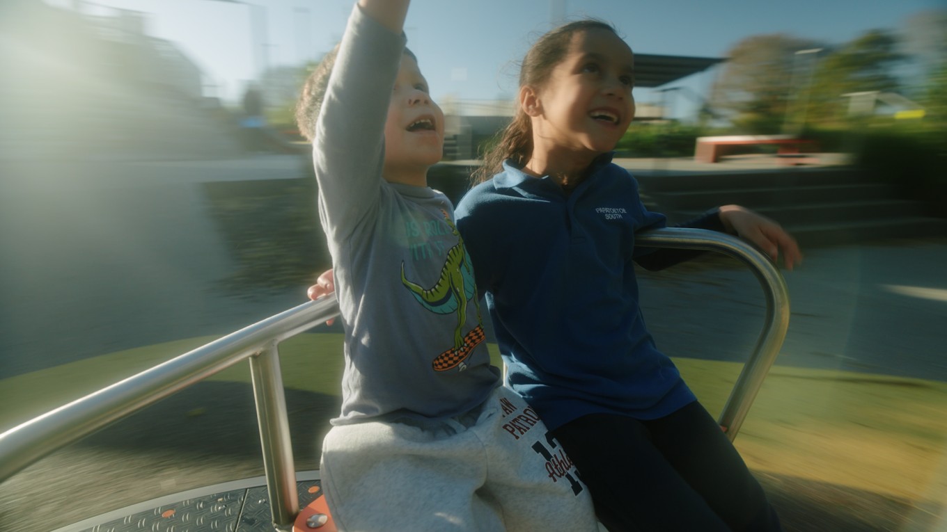 Childing playing on a merry go round. 
