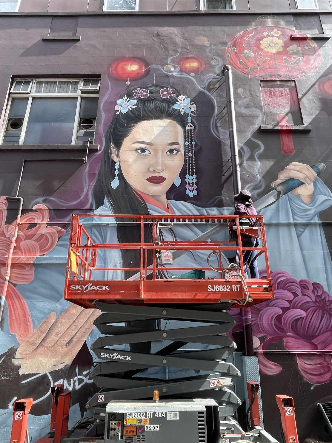 A mural of a martial artist with a sword in her hand. 