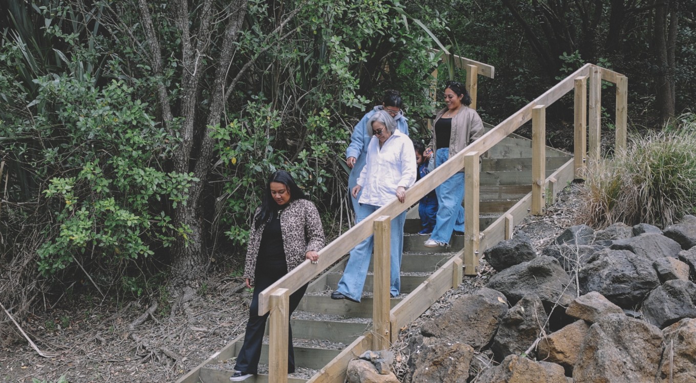 Three ladies walking down a staircase. 
