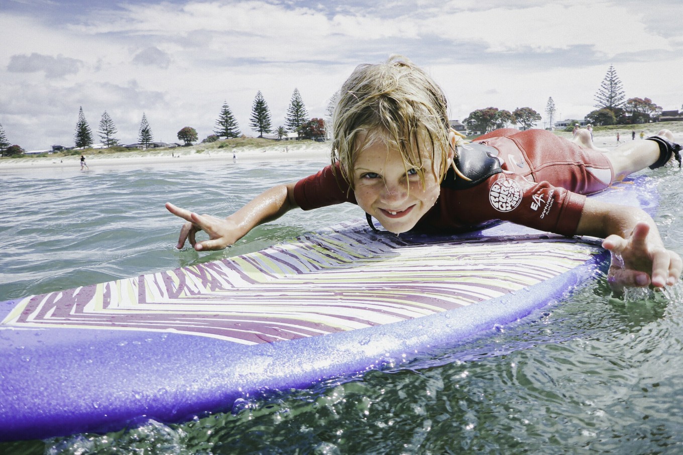 A kid on a surfboard. 