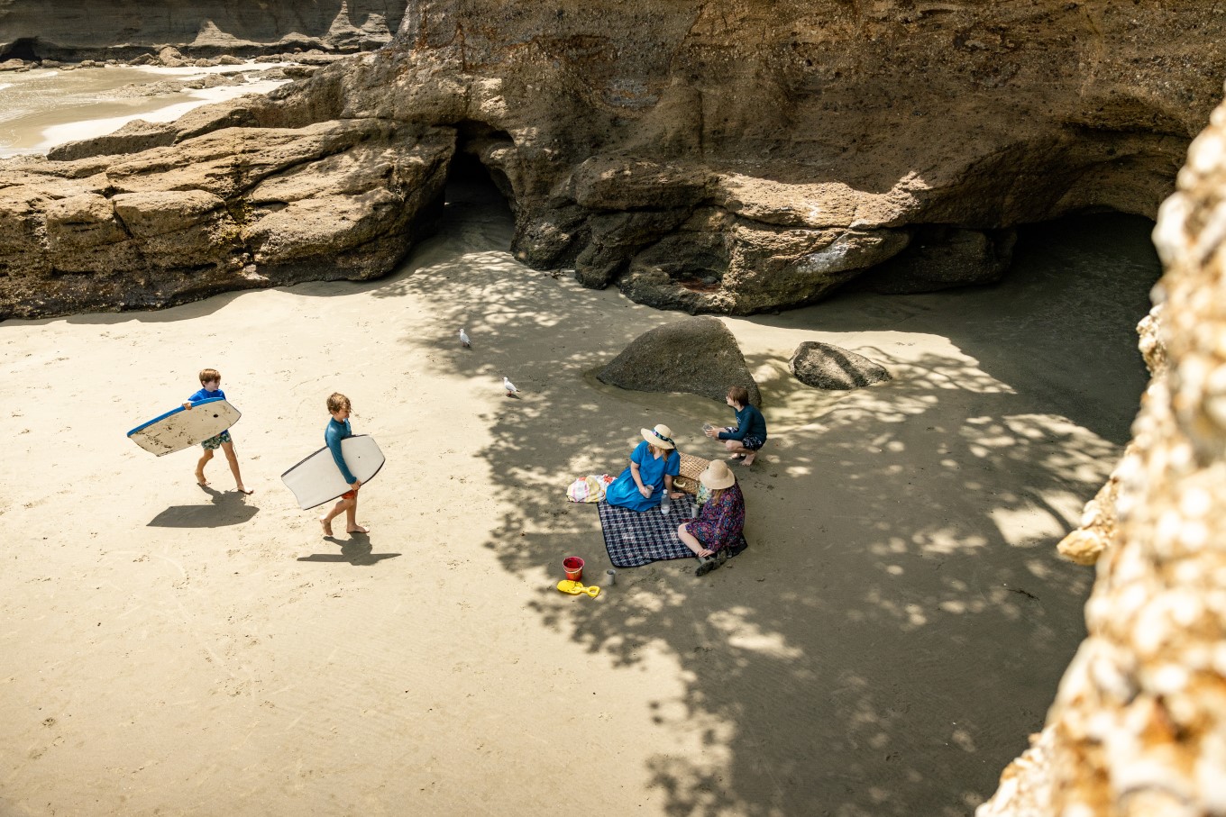 Families at Tāwharanui Regional Park beach.