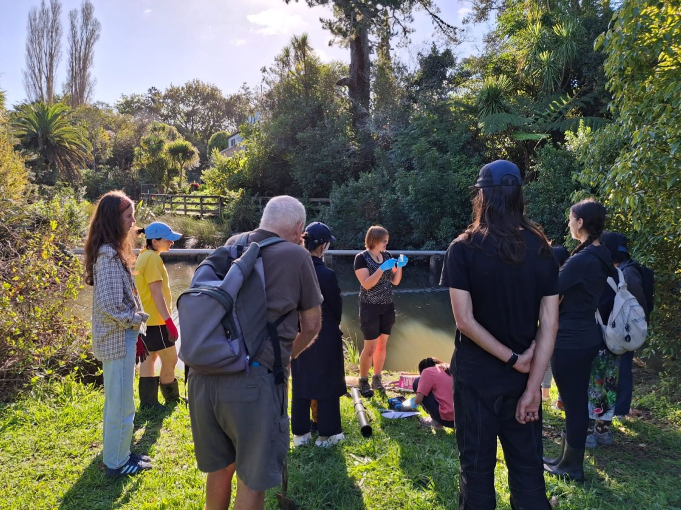 A gathering of people by a local river.